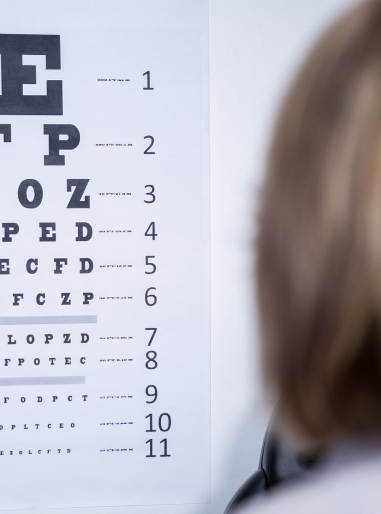 optometrist-looking-at-eye-chart.jpg
